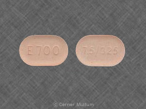 Endocet 7.5-325 mg Orange Oval Tablet – Oxycodone & Acetaminophen. Peach oval Endocet 7.5-325 mg tablet imprinted “E700 7.5/325” representing oxycodone/acetaminophen pain relief medication.