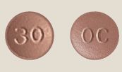 OxyContin 30 mg ER Tablet – Controlled-Release Oxycodone Pill. Brown round OxyContin 30 mg extended-release oxycodone tablet marked “30.”